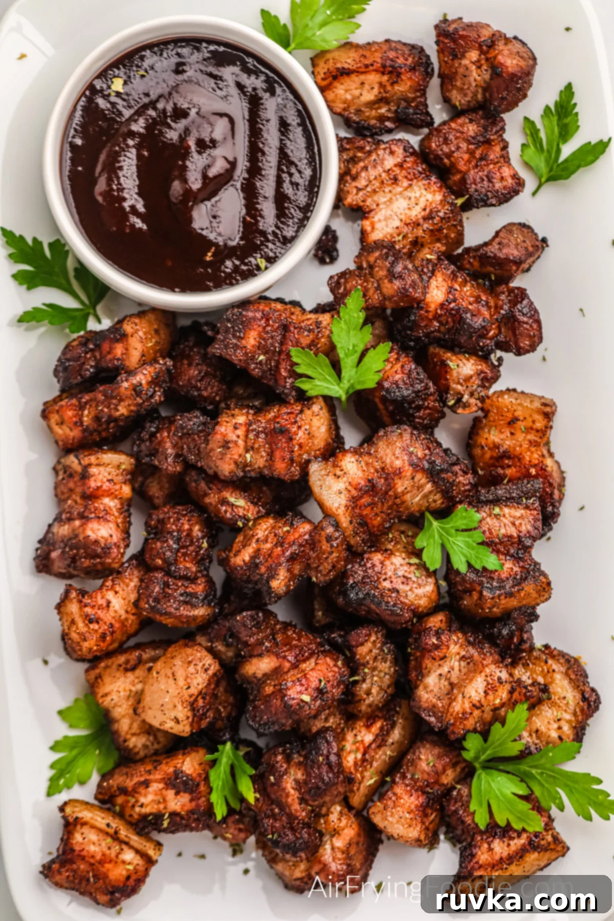 Air Fried Pork Belly Perfection 5 Overhead shot of crispy pork belly bites on a platter with BBQ dipping sauce.
