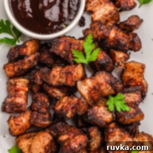 Air Fried Pork Belly Perfection 7 Overhead photo of crispy air fryer pork belly bites in a serving platter with BBQ dipping sauce.