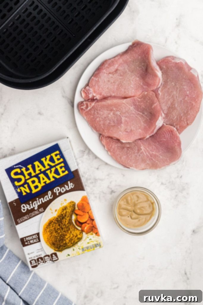 Crispy Air Fryer Pork Chops 3 Ingredients on a white marble table to make shake and bake pork chops