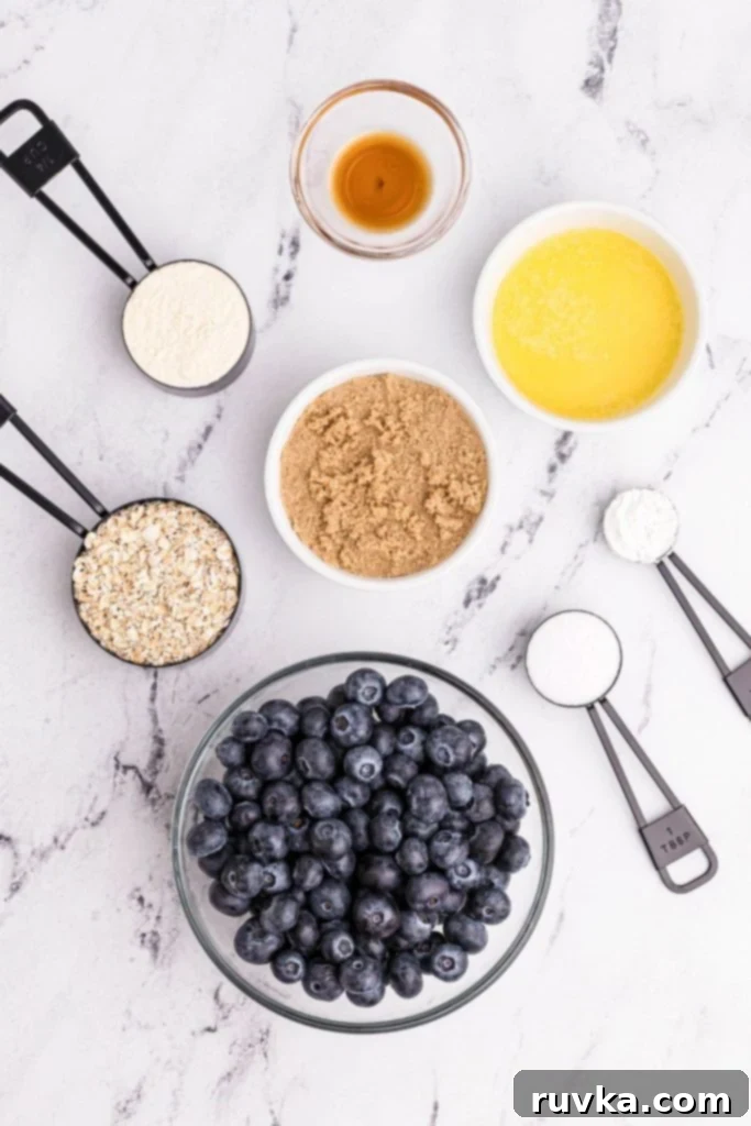 Easy Air Fryer Blueberry Crisp 3 Ingredients for air fryer blueberry crisp laid out on a table in measuring cups and spoons