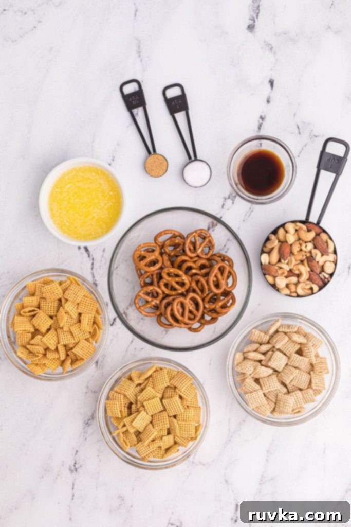 Easy Air Fryer Chex Mix 3 Ingredients needed for Chex mix on the table with pretzels, nuts, cereal, and others in measuring cups