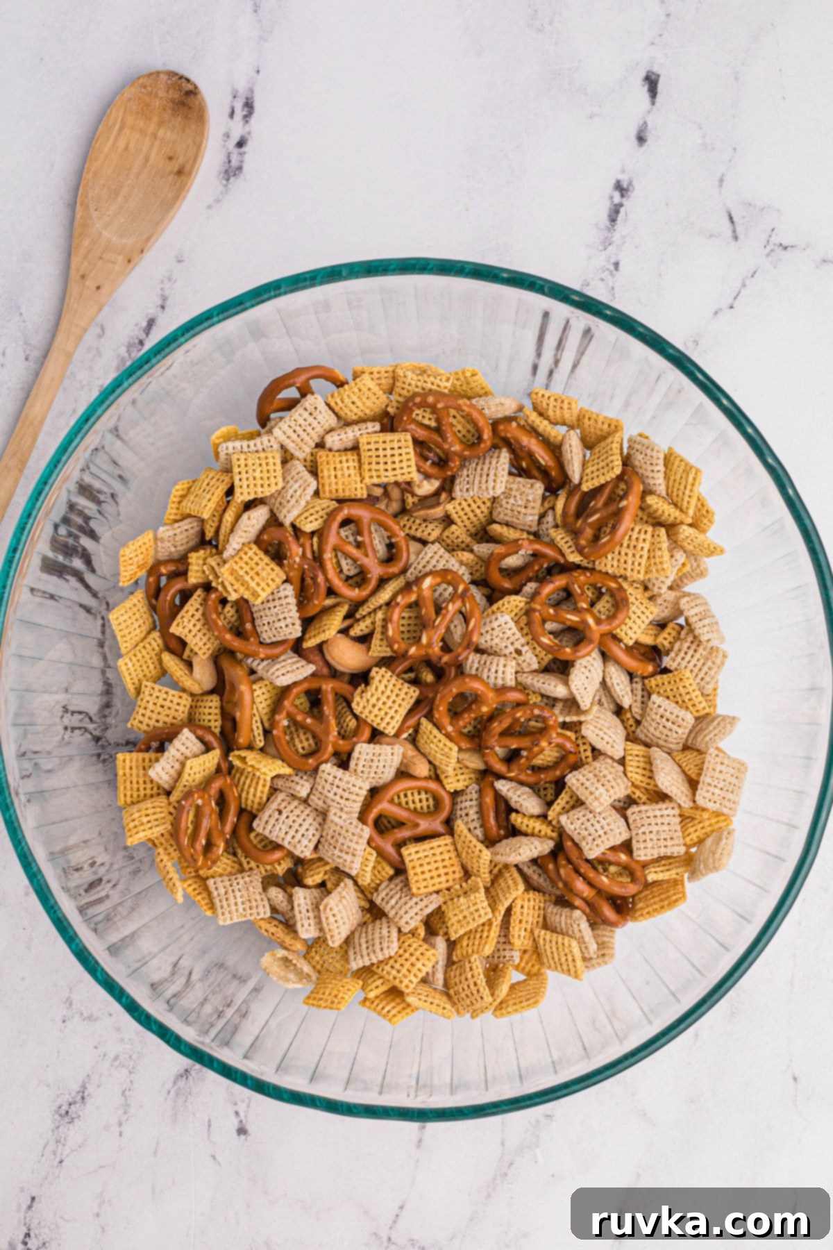 Easy Air Fryer Chex Mix 4 Chex mix in a clear glass bowl before being mixed with seasonings and sauce