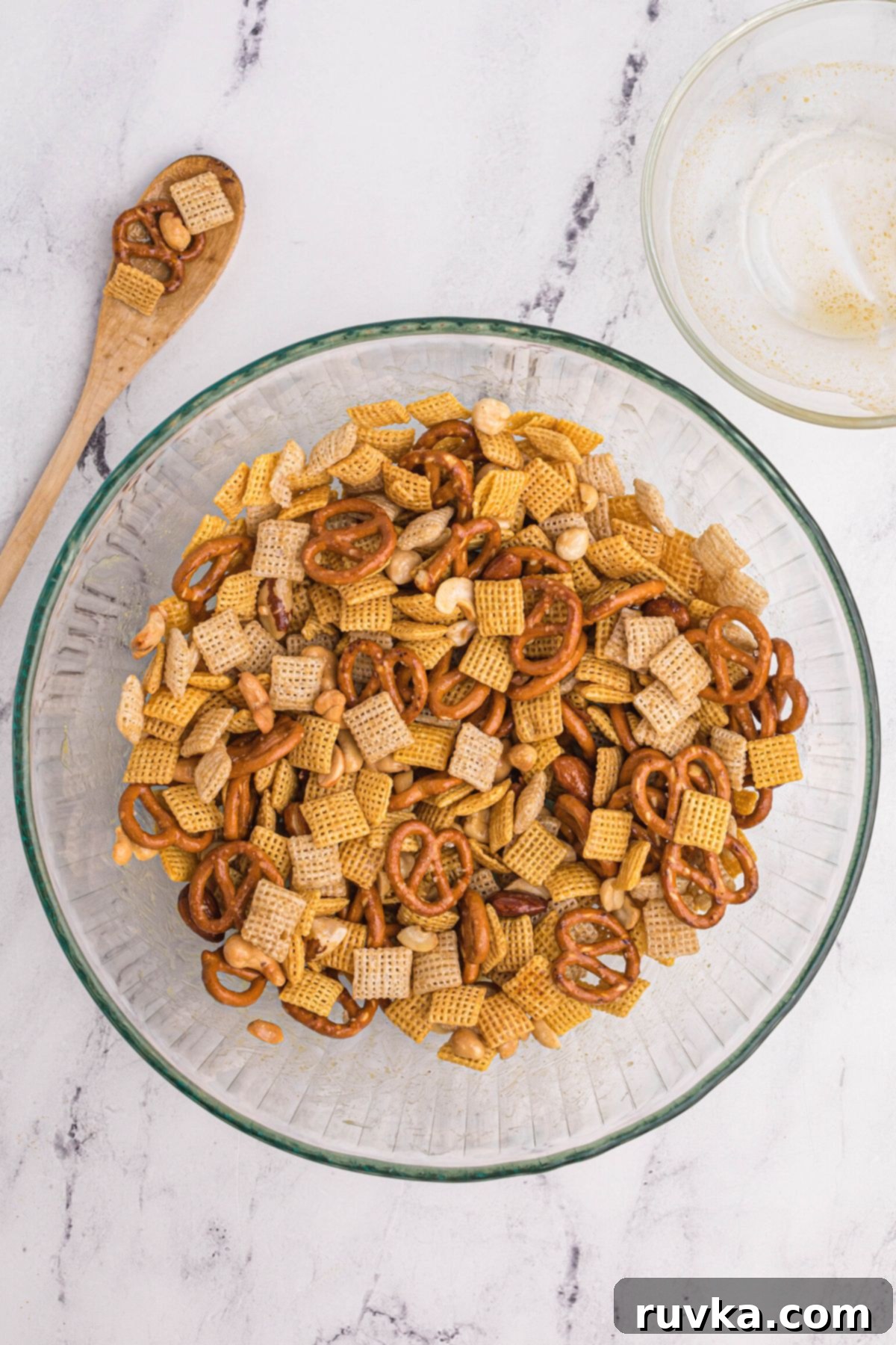 Easy Air Fryer Chex Mix 6 Clear glass bowl with chex cereals mixed together