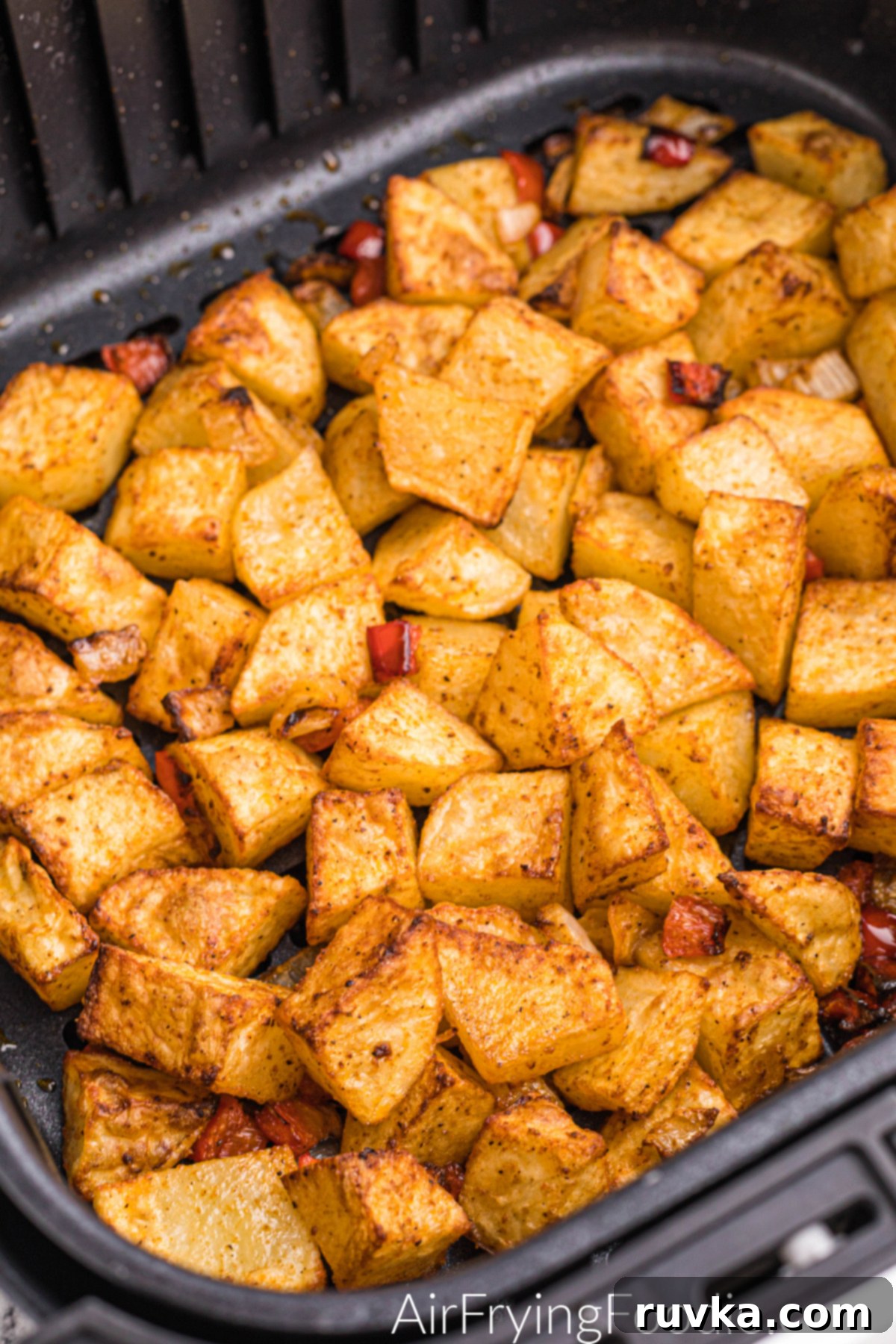 Crispy Air Fryer Home Fries 2 Perfectly seasoned and crispy home fries in the basket of an air fryer, ready to be served.