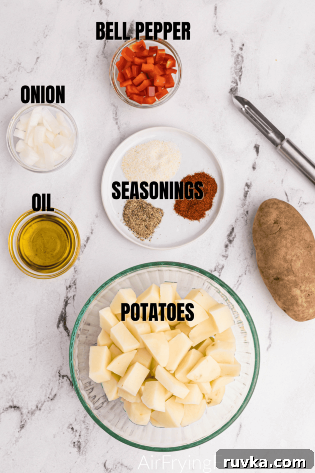 Crispy Air Fryer Home Fries 4 All the fresh ingredients like russet potatoes, bell pepper, and onion, along with seasonings and olive oil, laid out for making home fries.
