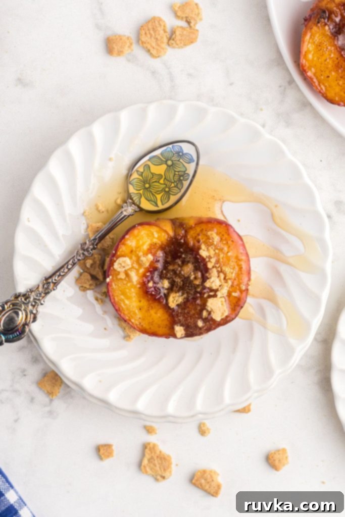 Golden Air-Fried Peaches 9 Juicy peach on a white plate with a silver and blue spoon drizzling honey on top