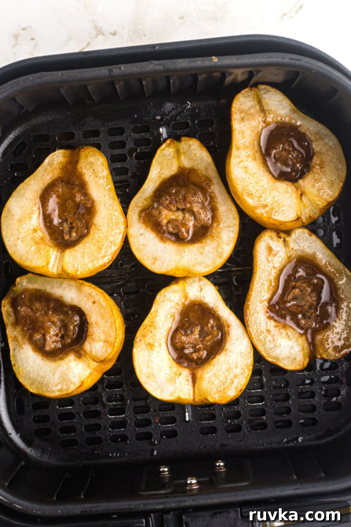 Golden Air Fryer Pears 7 Pears turned face up in the air fryer basket