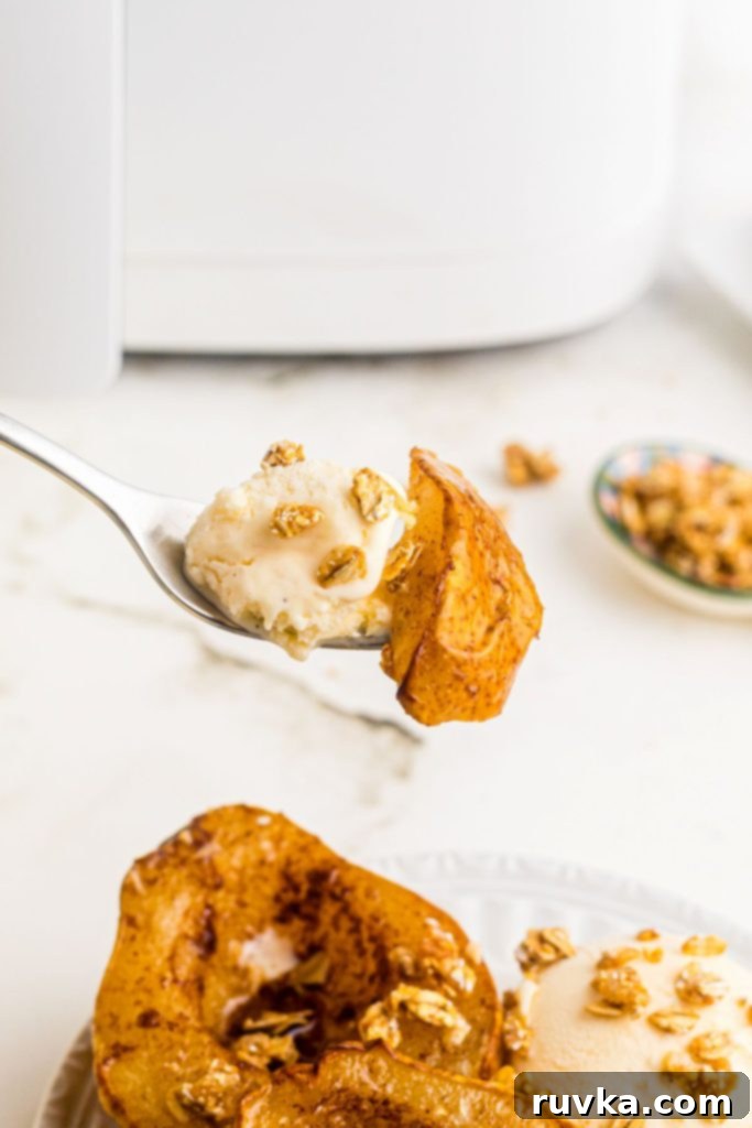 Golden Air Fryer Pears 10 Fork with bite of air fried pear and a small bite of ice cream.