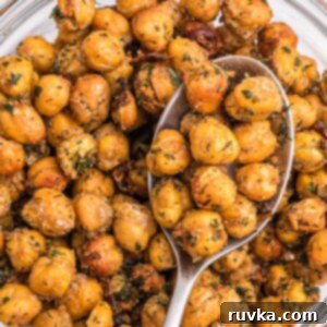 Crispy Air Fryer Chickpeas 9 Golden crispy brown chickpeas in a white bowl with a serving spoon