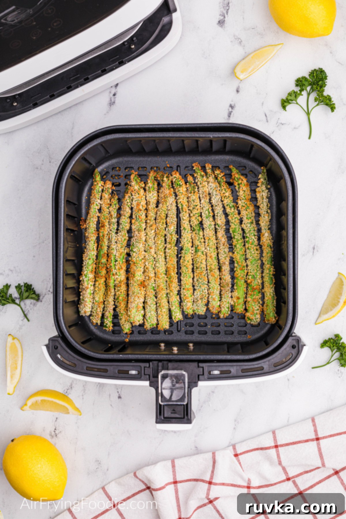 Crispy Air-Fried Asparagus Sticks 5 Air fried asparagus fries in the basket of the air fryer.