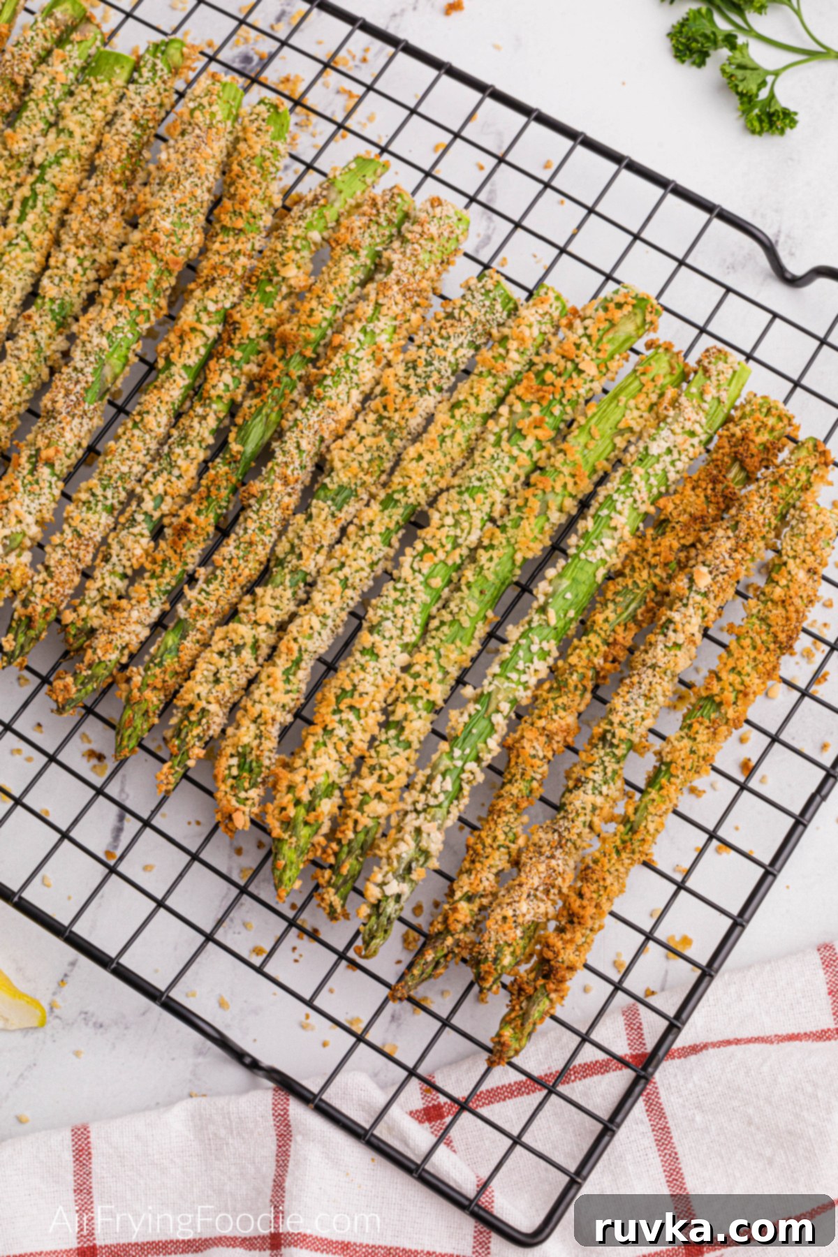 Crispy Air-Fried Asparagus Sticks 6 air fried asparagus fries on a cooling rack.