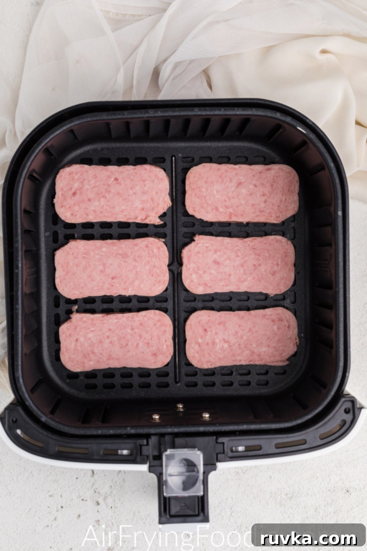 Crispy Air-Fried Spam 4 Spam in the basket of the air fryer ready to cook.