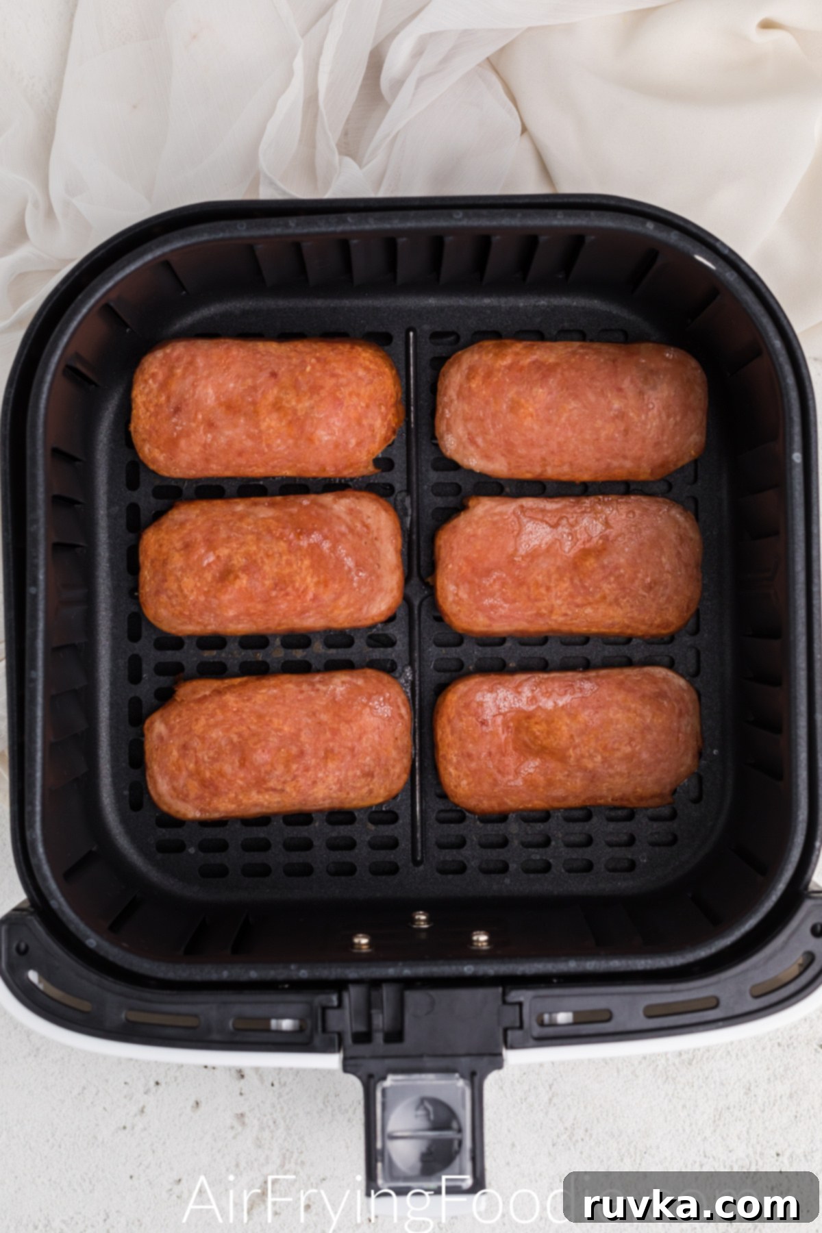 Crispy Air-Fried Spam 5 Cooked Spam in the basket of the air fryer.