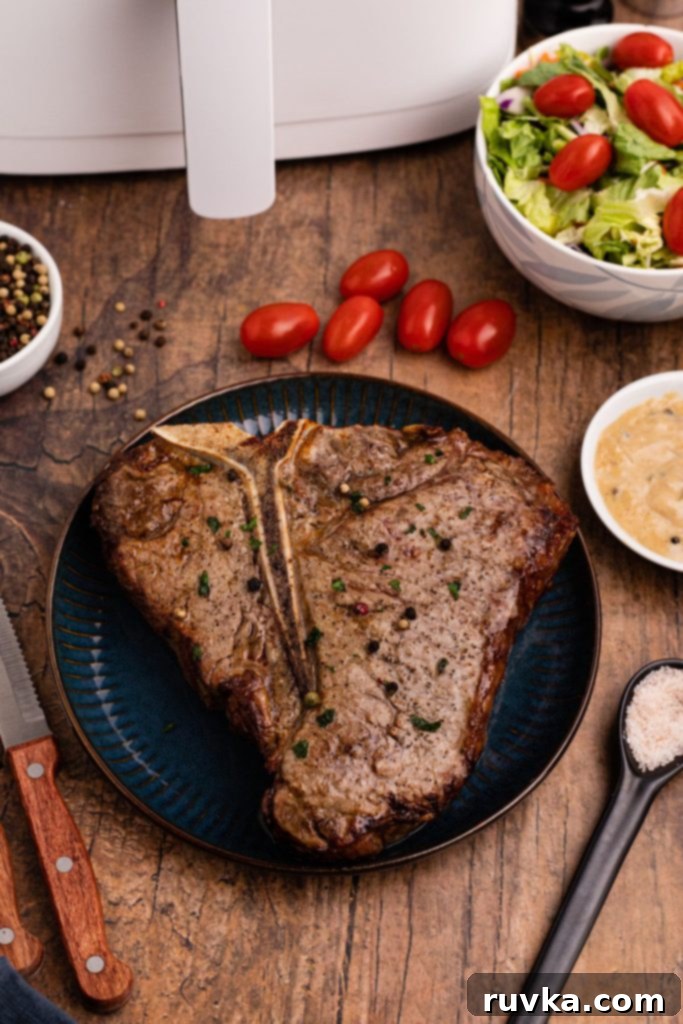 Restaurant-Quality Air Fryer T-Bone 2 Juicy tbone steak on a blue plate served on a wooden table, perfectly cooked in the air fryer.