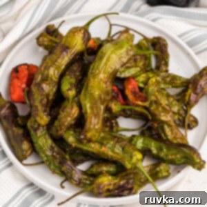 Crispy Air Fryer Shishito Peppers 7 Overhead picture of air fried shishito peppers on a white plate.