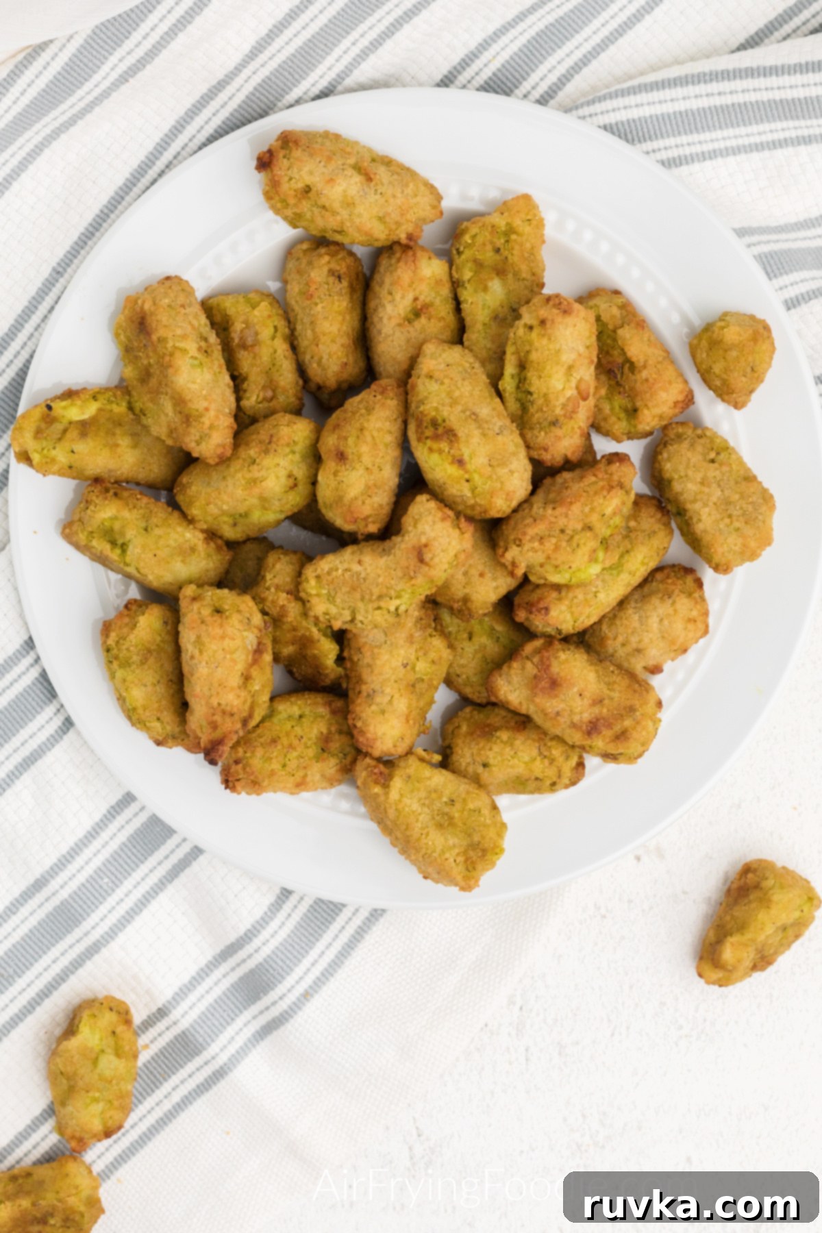 Wholesome Crispy Air Fryer Veggie Tots 5 Overhead photo of air fried veggie tots on a white plate, ready to serve.