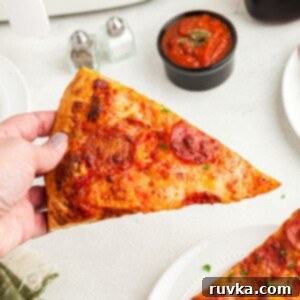 Air Fryer Magic: Crispy Leftover Pizza Every Time 7 Golden crispy slice of pepperoni pizza after being cooked in the air fryer