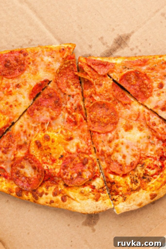 Air Fryer Magic: Crispy Leftover Pizza Every Time 3 Uncooked pepperoni slices of pizza in a cardboard pizza box