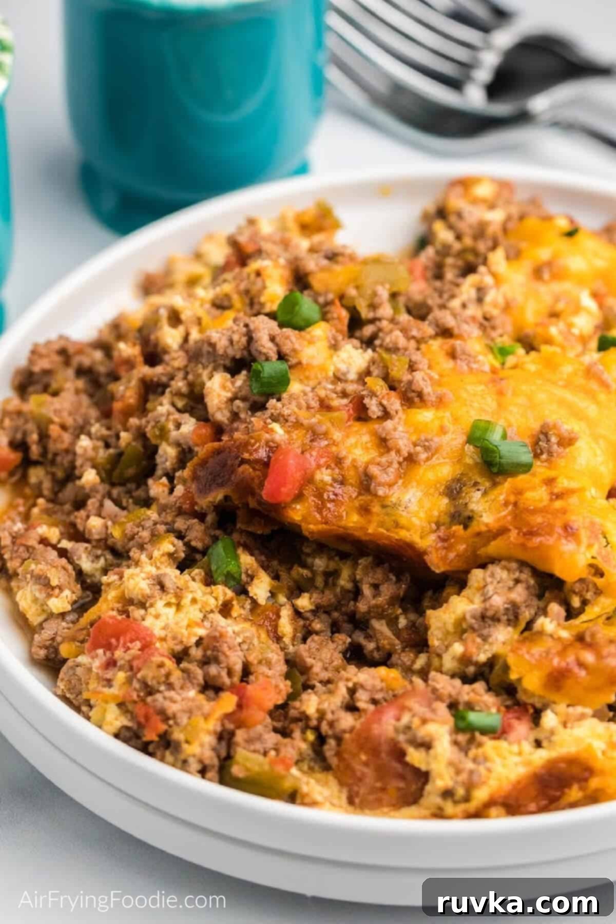 Crispy Air Fryer Taco Bake 2 Close up of air fryer taco casserole on a white plate, ready to serve.