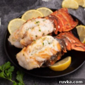 Crispy Air-Fried Lobster Tails 9 Cooked Air Fryer Lobster Tails, golden and delicious, ready to be served. A vibrant display of cooked lobster tails, fresh and inviting, with a generous drizzle of garlic butter.