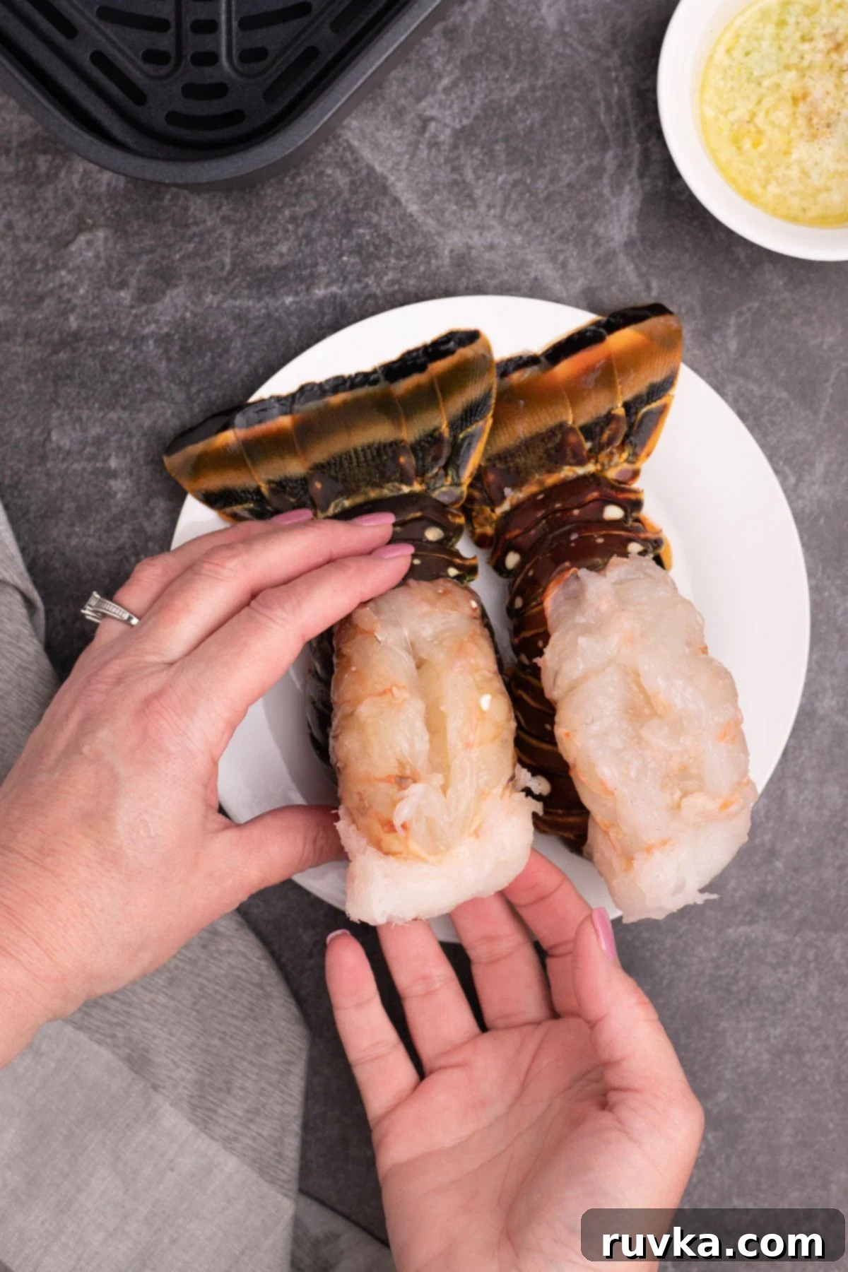 Crispy Air-Fried Lobster Tails 5 Lobster tails cut and opened, with meat being pulled up to rest on top of the shell. A perfectly butterflied lobster tail with its tender meat gently pulled out and artfully resting on top of the opened shell, ready for seasoning.