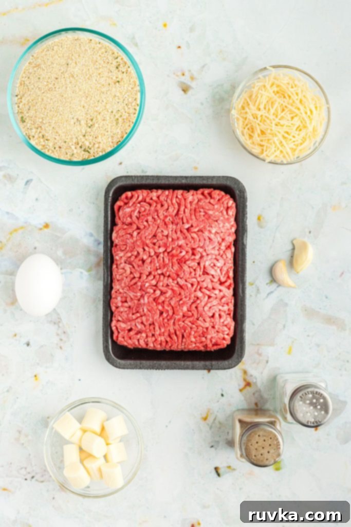 Crispy Air Fryer Cheese Stuffed Meatballs 3 Ingredients needed to make cheese stuffed meatballs measured out on a marble table.
