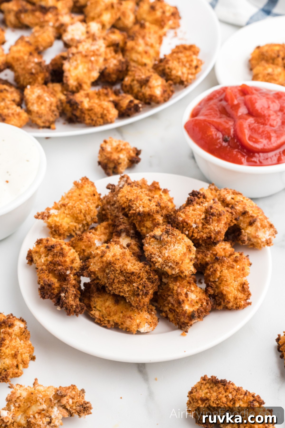 Air-Fried Chicken Poppers 8 Perfectly golden and crispy Air Fryer Popcorn Chicken served on a plate, ready to be enjoyed.