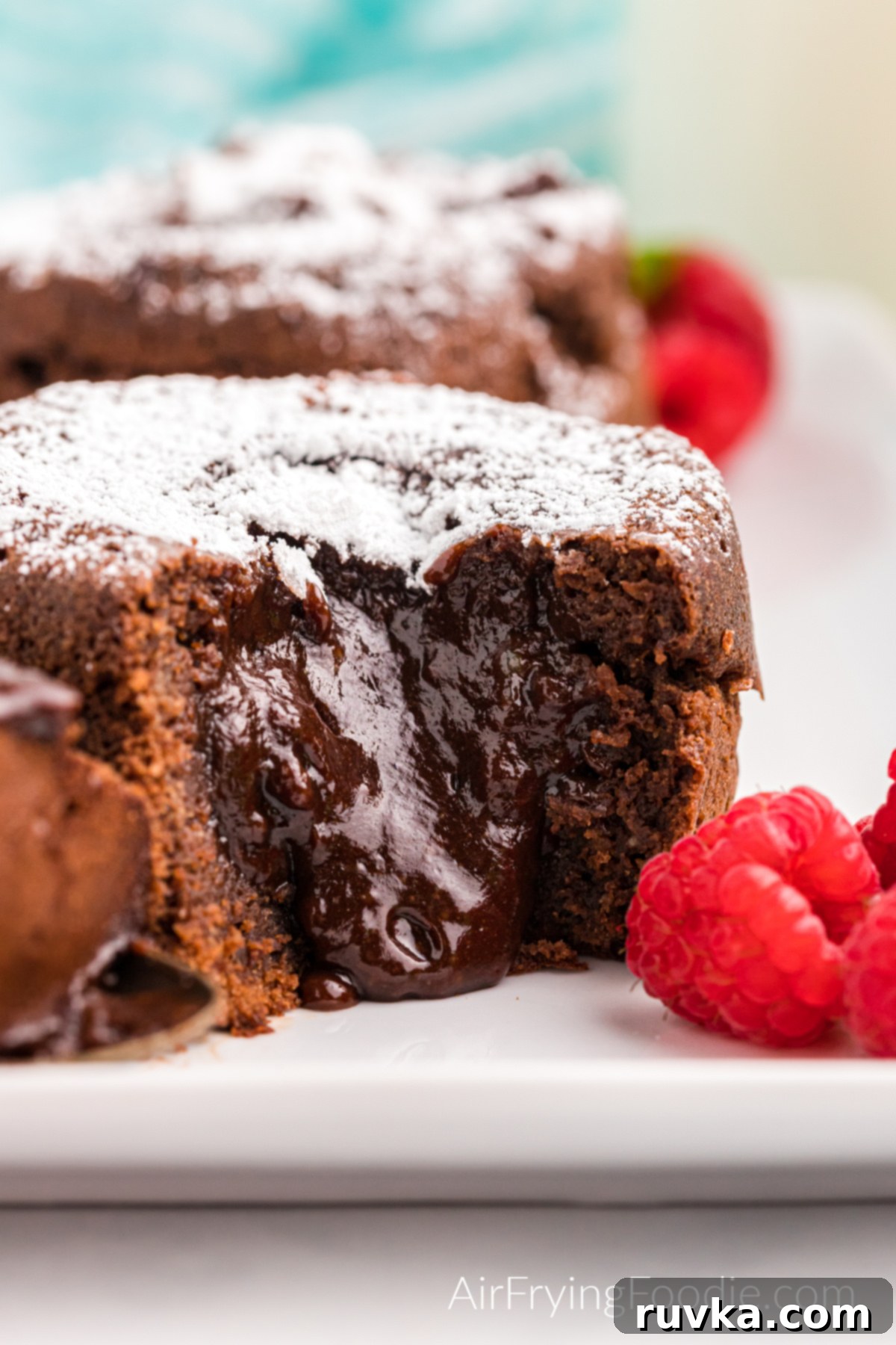 Easy Air Fryer Molten Chocolate Cakes 2 Close up of lava cake missing a bite with chocolate oozing from the center.