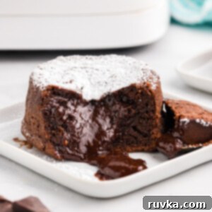Easy Air Fryer Molten Chocolate Cakes 10 Lava cake bite shot on a white plate.