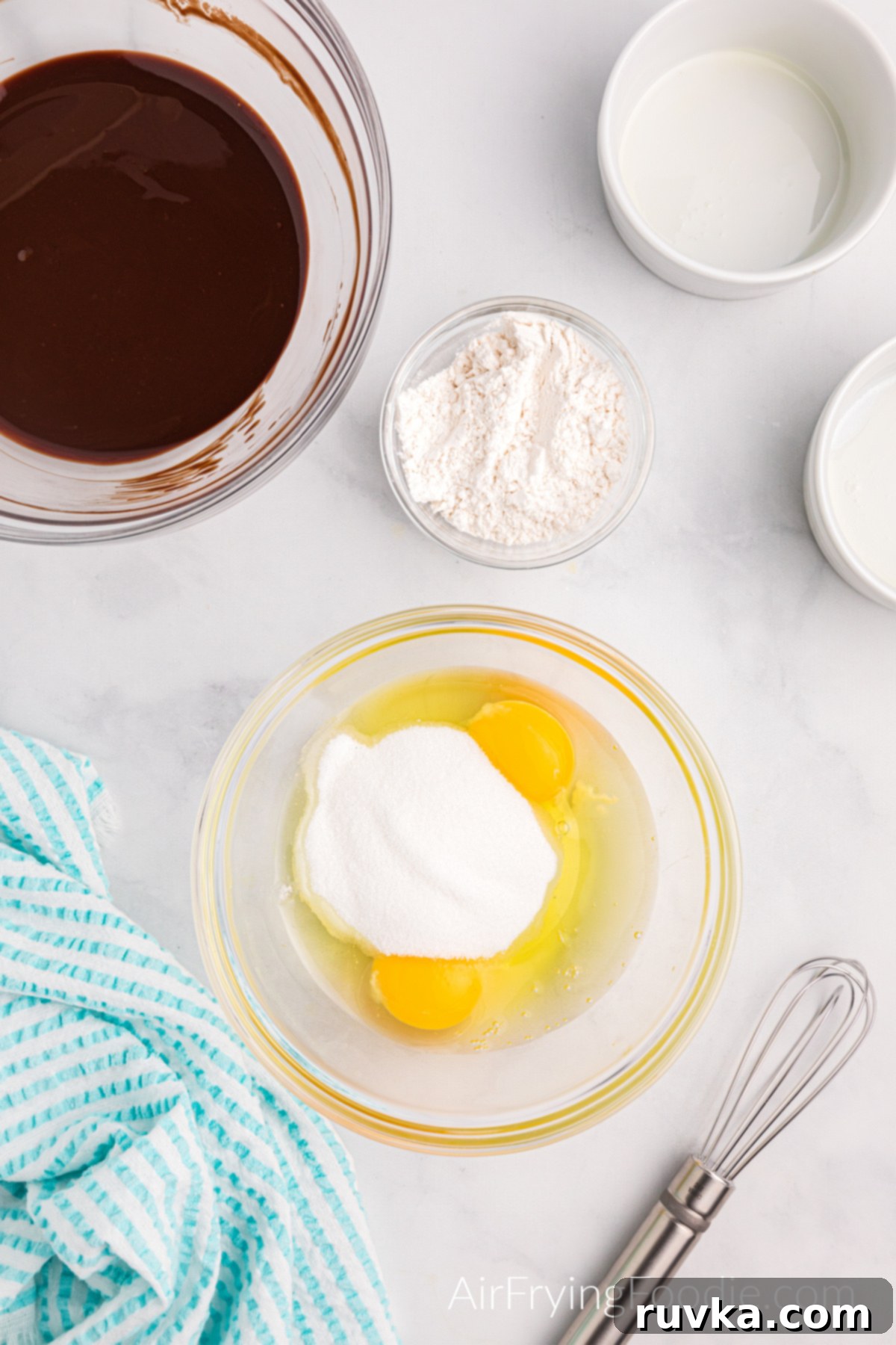 Easy Air Fryer Molten Chocolate Cakes 6 Eggs in a bowl ready to be whisked and added to the chocolate.