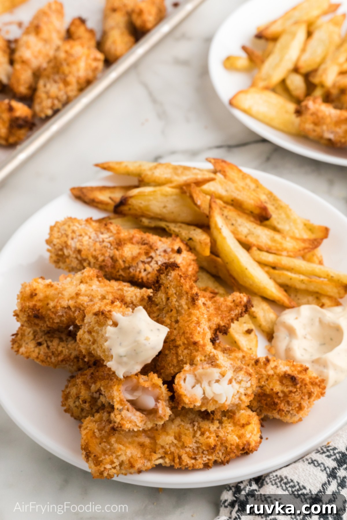 Crispy Air Fried Fish And Chips 2 Crispy Air Fryer Fish and Chips served with dipping sauces.