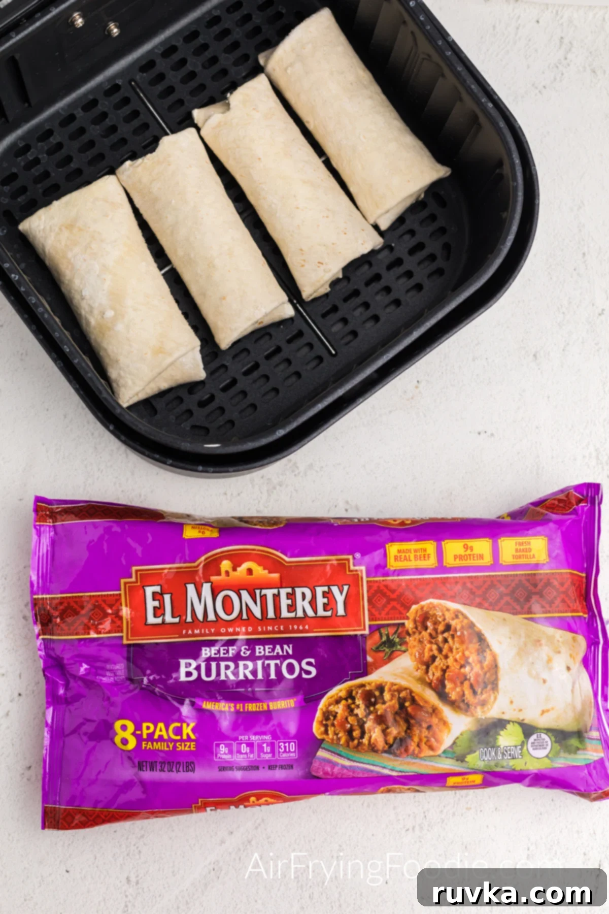 Perfectly Crispy Air Fried Frozen Burritos 3 Several frozen burritos resting neatly in the basket of an air fryer, poised for cooking to achieve a perfectly crispy texture.