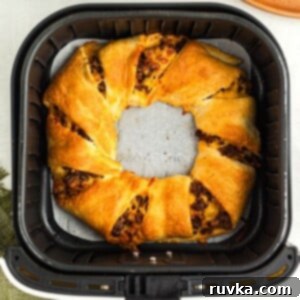 Quick Air Fryer Back to School Dinners 7 Golden crescent rolls wrapped around taco meat and seasonings, forming an Air Fryer Taco Ring.