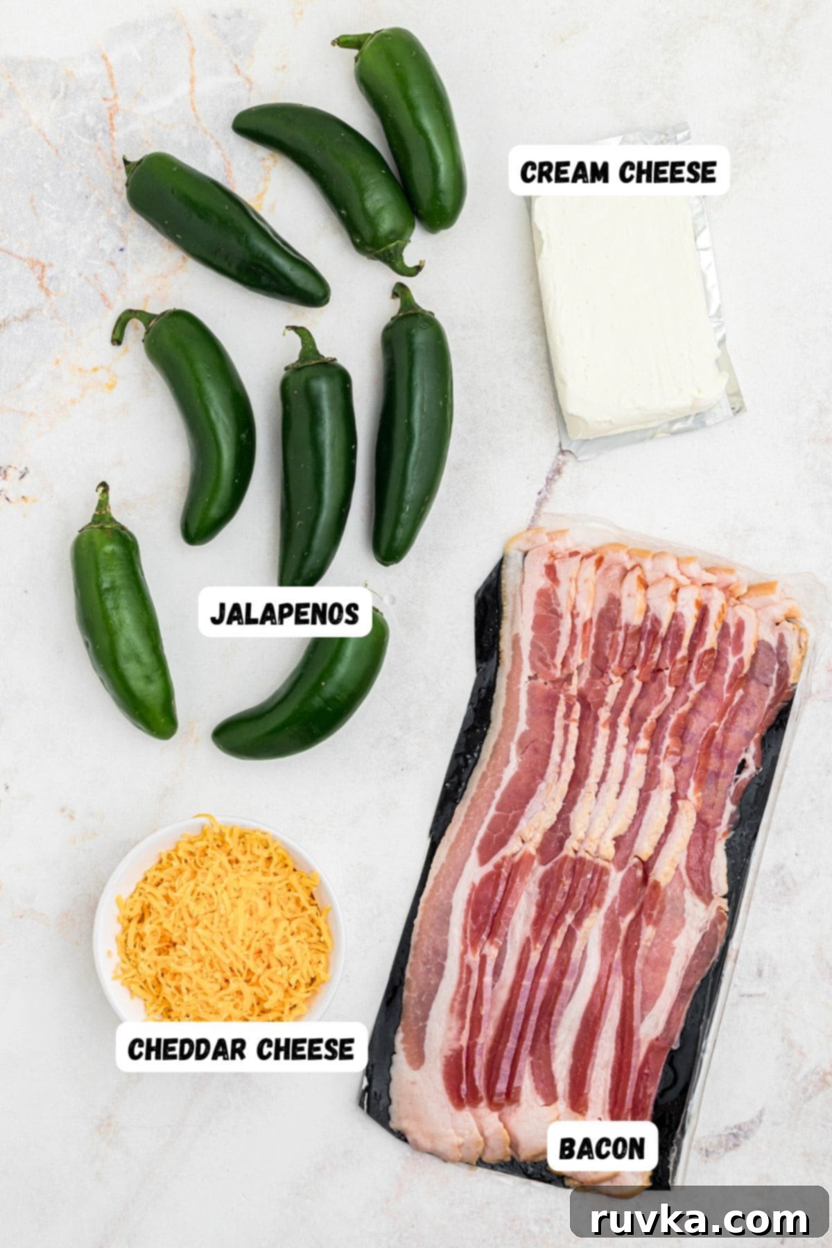 Crispy Air Fryer Jalapeño Poppers 3 Bacon, cheese, cream cheese, and jalapenos, on a marble table.