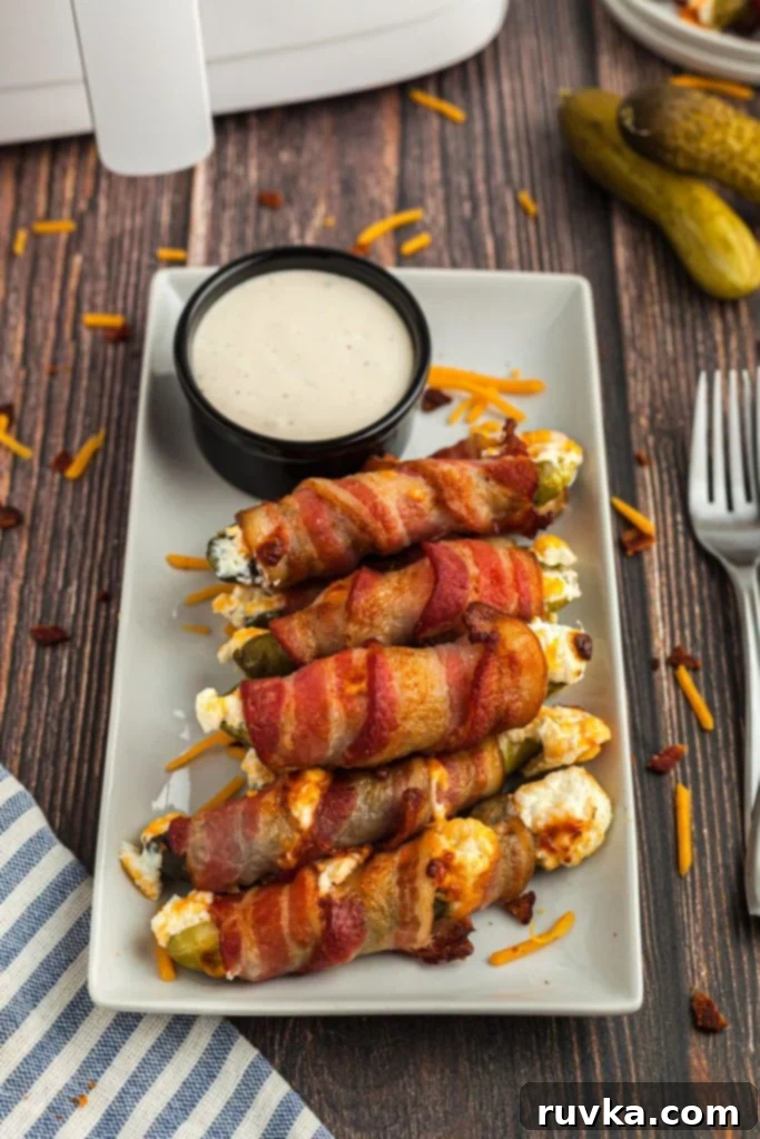 Air-Fried Pickle Bites 2 Rectangle plate with bacon wrapped pickles filled with cream cheese