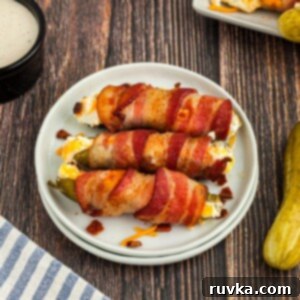 Air-Fried Pickle Bites 10 Bacon wrapped pickle poppers on a small white plate