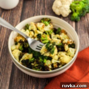 Crispy Air Fried Broccoli Cauliflower 8 Green broccoli and white cauliflower in a cream bowl on a wooden table