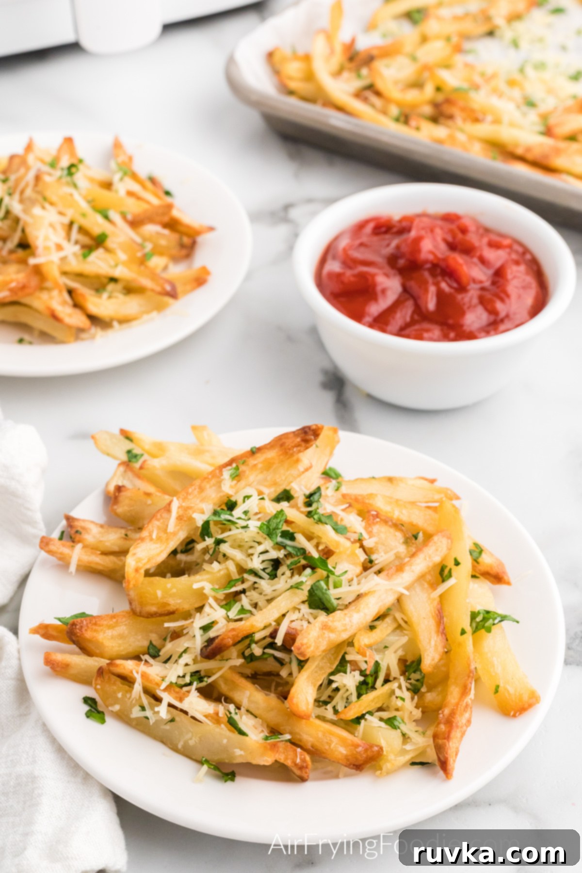 Crispy Air Fryer Truffle Fries 2 Air fried truffle fried on a white plate with a side of ketchup.