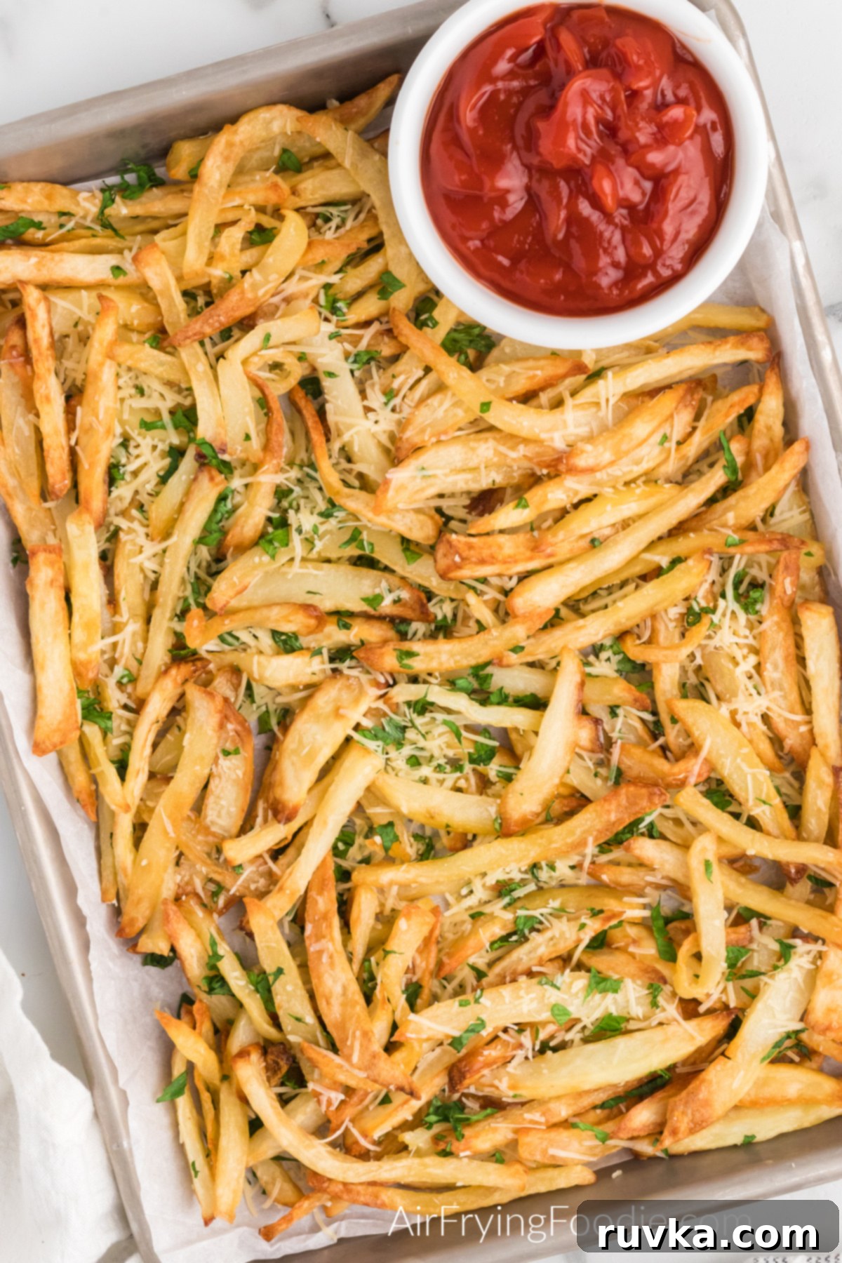 Crispy Air Fryer Truffle Fries 11 Truffle fries on a serving platter with a side of ketchup.