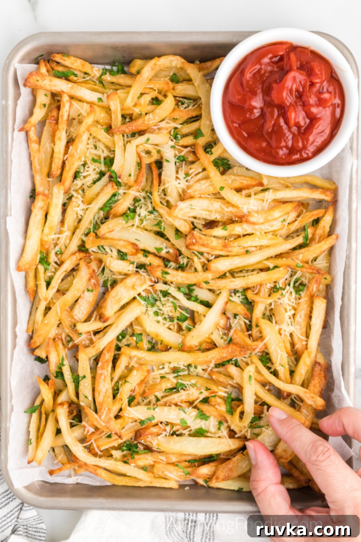 Crispy Air Fryer Truffle Fries 10 Truffle fries on a serving platter with a side of ketchup.