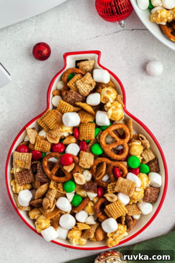 Crispy Air Fryer Reindeer Chow 9 Crispy and bright cereals and candies mixed together in a fun shaped bowl on a marble table