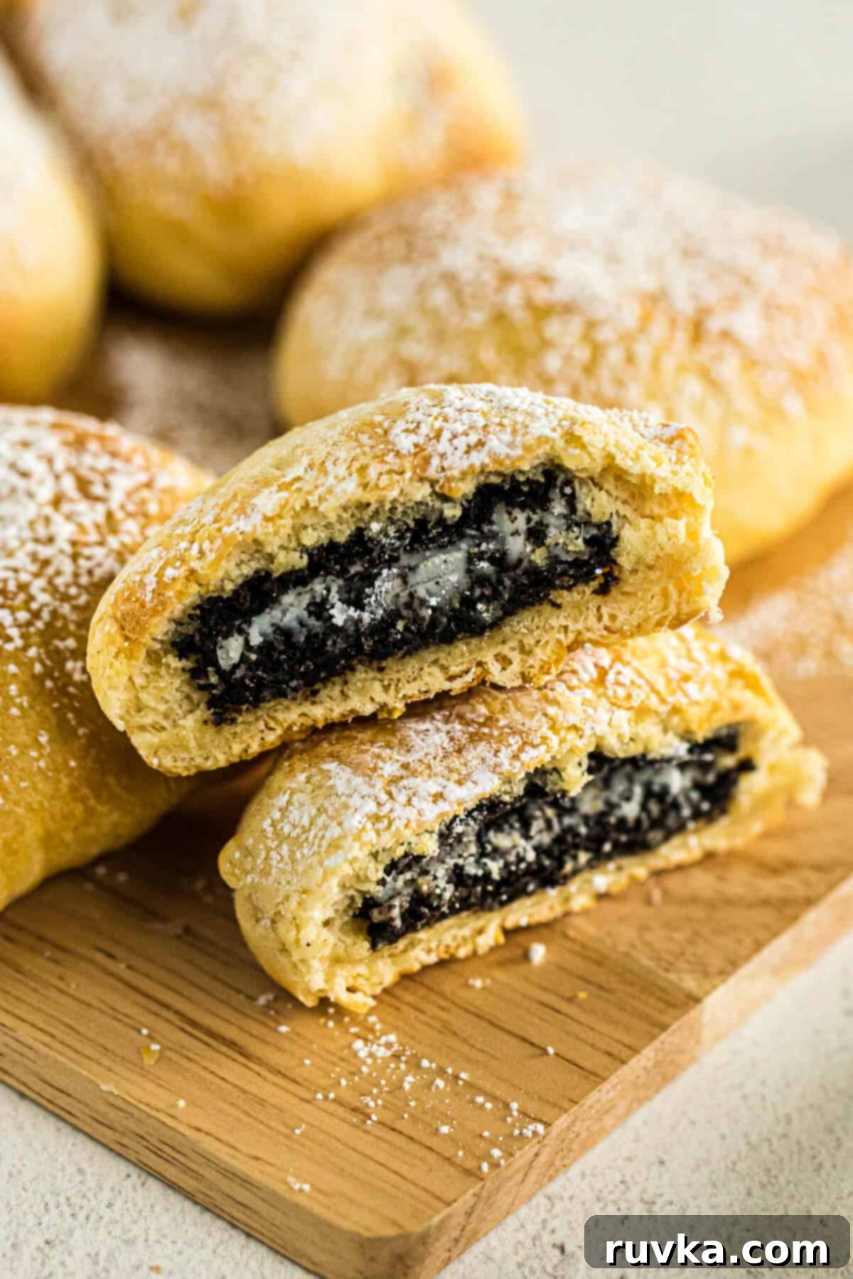 Air Fried Oreo Magic 2 Air fryer fried Oreos on a cutting board with powdered sugar sprinkled on top.
