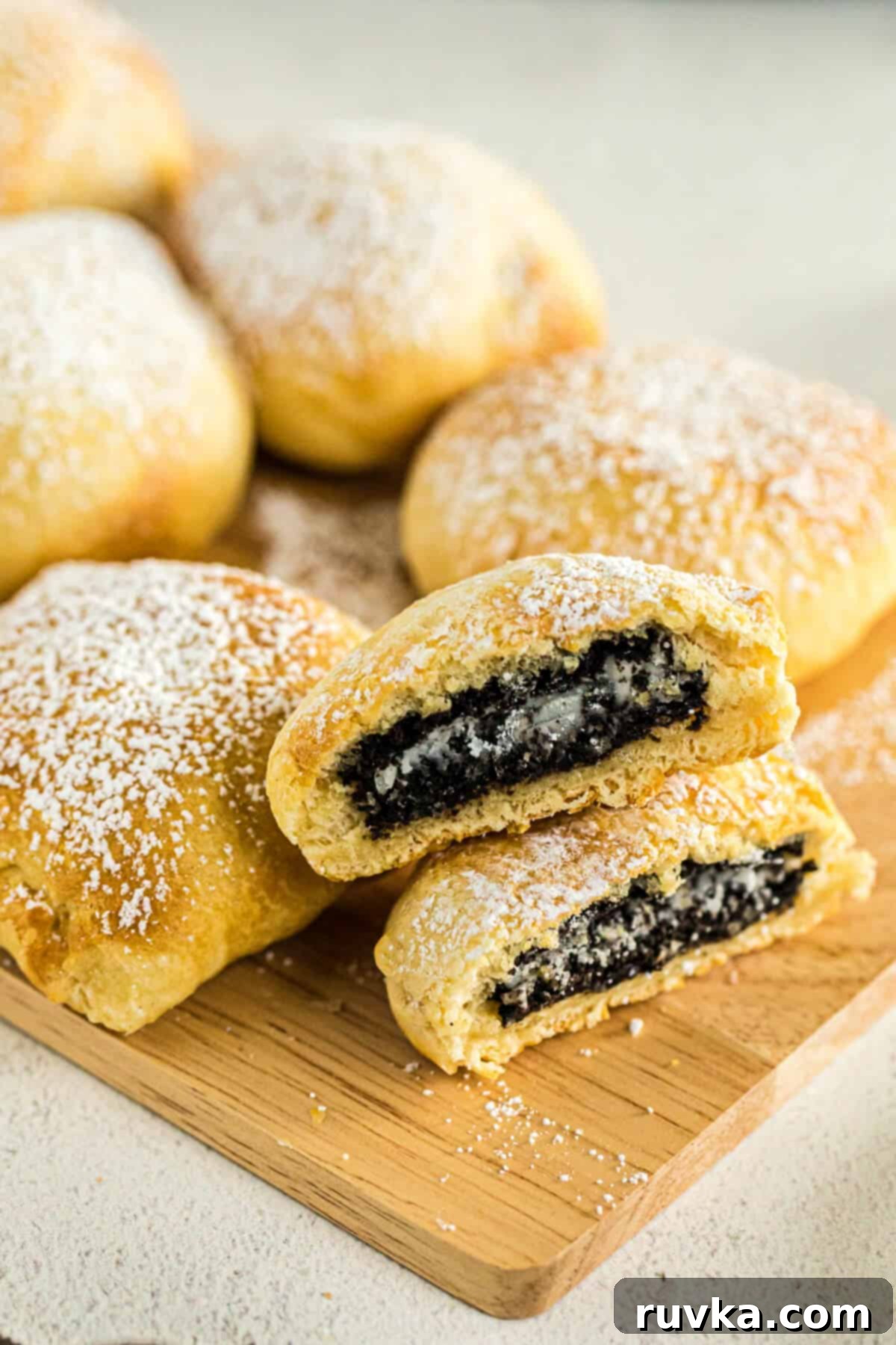 Air Fried Oreo Magic 5 Air fried oreos on a cutting board sprinkled with powdered sugar.