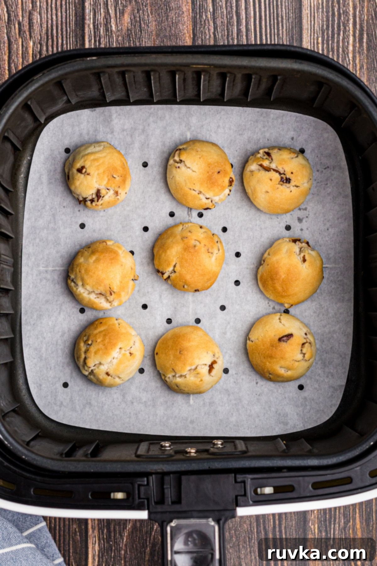 Golden air fried snowball cookies cooling on a wire rack