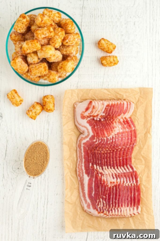 Crispy Air Fryer Bacon-Wrapped Tater Tots 3 Ingredients needed to make bacon wrapped tater tots on a white wooden board