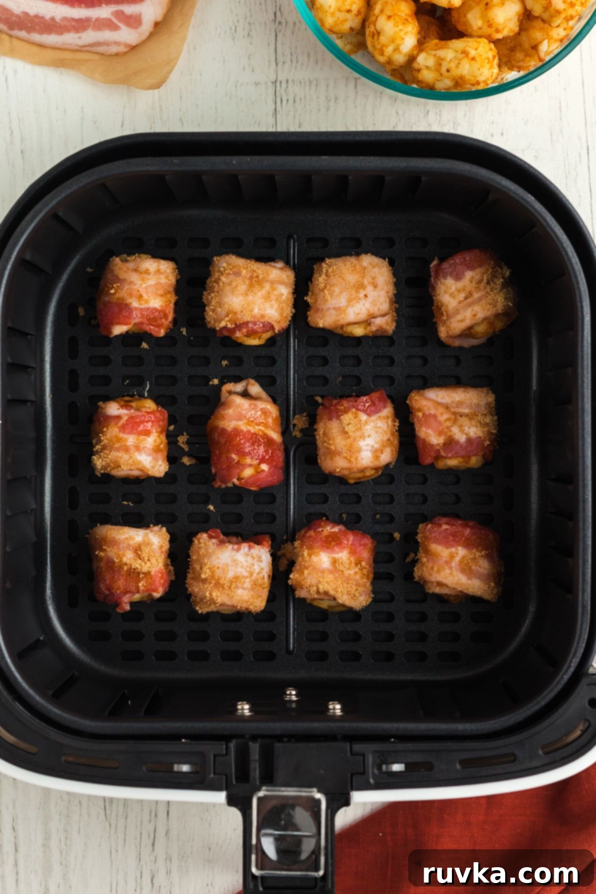 Crispy Air Fryer Bacon-Wrapped Tater Tots 7 Bacon wrapped and sugar coated tater tots in the air fryer basket