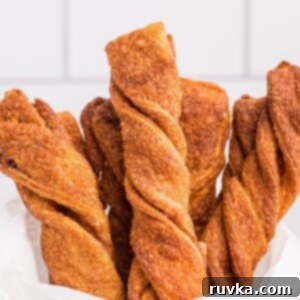 Air Fried Cinnamon Delights 11 Golden sugar and cinnamon coated twists stacked in parchment paper