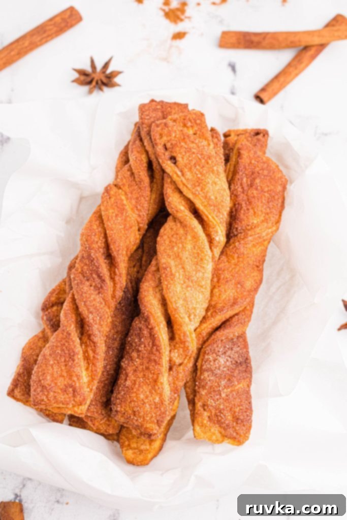 Air Fried Cinnamon Delights 10 Golden crispy cinnamon twists stacked on parchment paper