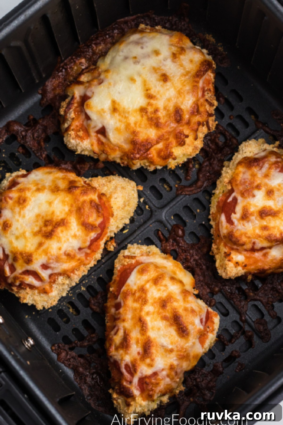Crispy Air Fryer Chicken Parmesan 5 Chicken parmesan in basket of air fryer ready to serve.