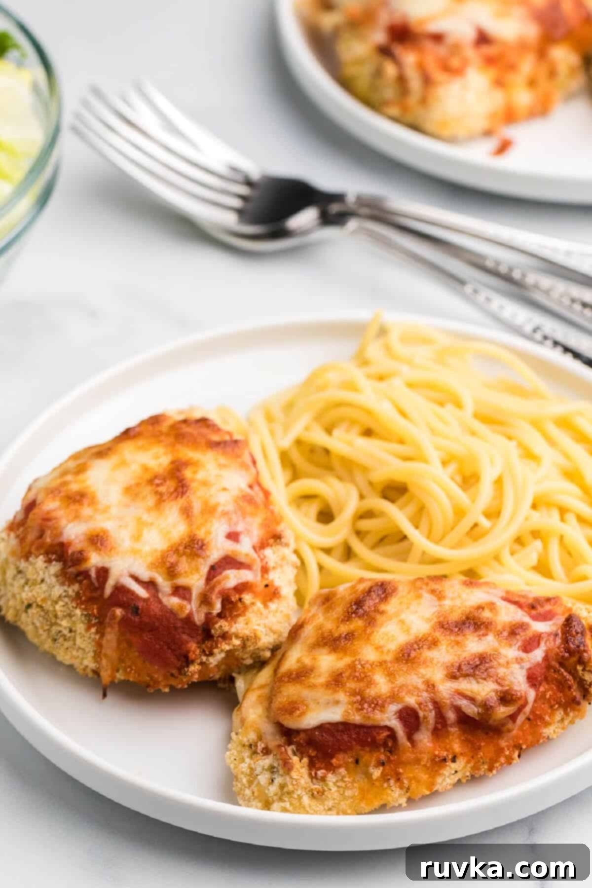 Crispy Air Fryer Chicken Parmesan 6 Air Fryer Chicken parmesan on a plate with noodles.